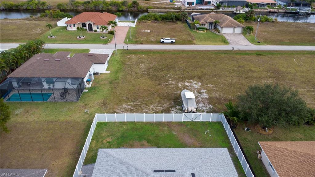 Image 3: Aerial perspective of suburban area featuring a large body of water