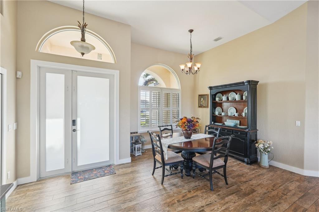 Image 2: Dining space with a chandelier and light wood finished floors