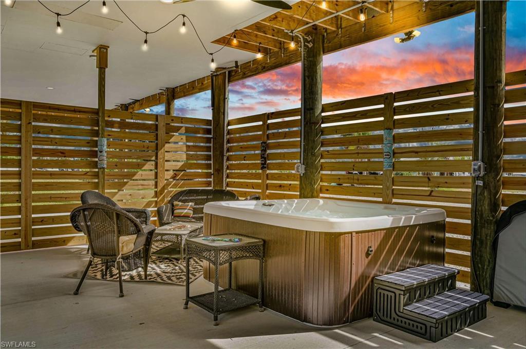 Image 2: View of patio featuring a hot tub