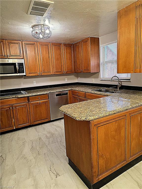 Image 2: Peninsula style kitchen with open serving to dining room