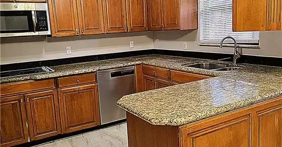 Image 2: Peninsula style kitchen with open serving to dining room