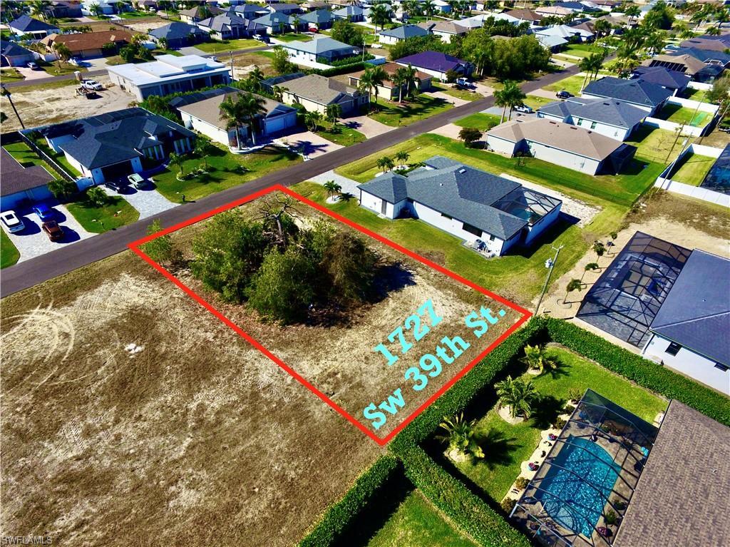 Image 3: Aerial view of residential area featuring property parcel outlined