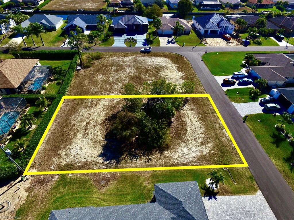 Image 4: Aerial view of residential area featuring property parcel outlined