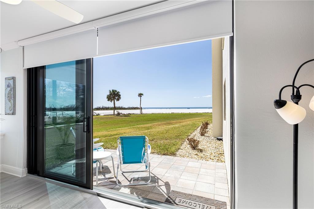 Image 2: Entryway featuring a water view, hardwood / wood-style flooring, and plenty of natural light