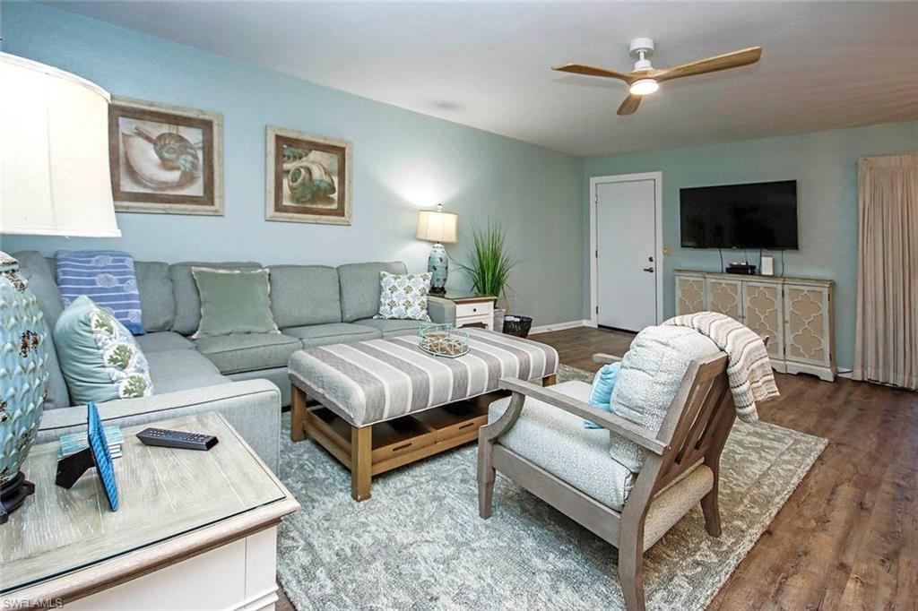 Image 3: Living room with baseboards, ceiling fan, and wood finished floors