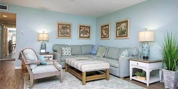Image 4: Living room with wood finished floors, a ceiling fan, visible vents, and baseboards