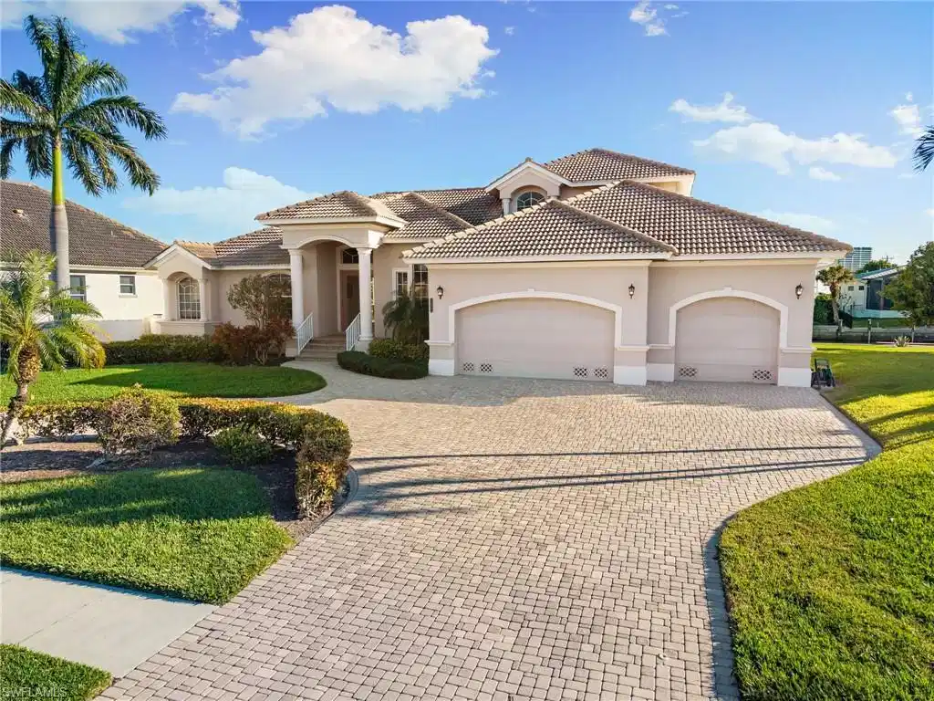 Image 1: Mediterranean / spanish-style home with a garage, driveway, stucco siding, a front yard, and a tiled roof