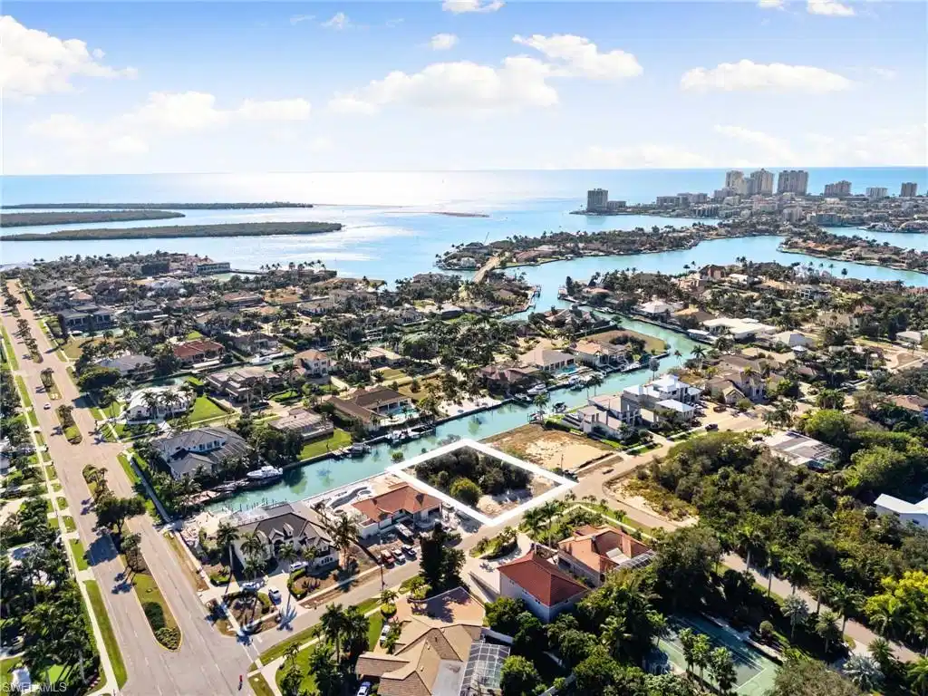 Image 1: Aerial view of property and surrounding area featuring nearby suburban area and a nearby body of water