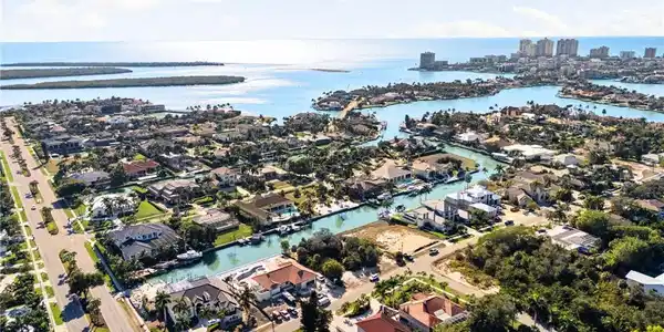 Image 2: Aerial view of property's location with nearby suburban area and a nearby body of water