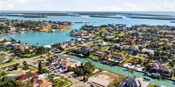 Image 3: Aerial view of property's location featuring nearby suburban area and a nearby body of water