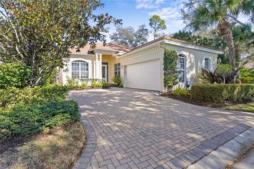 Image 2: Mediterranean / spanish home featuring stucco siding, decorative driveway, and an attached garage