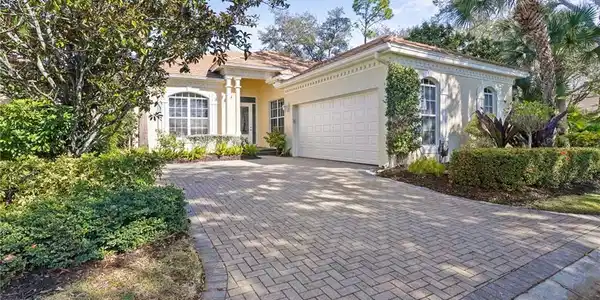 Image 2: Mediterranean / spanish home featuring stucco siding, decorative driveway, and an attached garage
