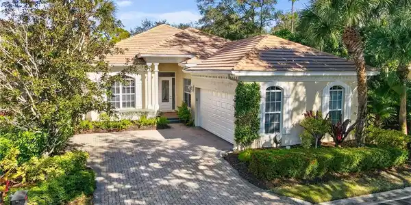Image 3: View of front of house with stucco siding, decorative driveway, a garage, and a tiled roof