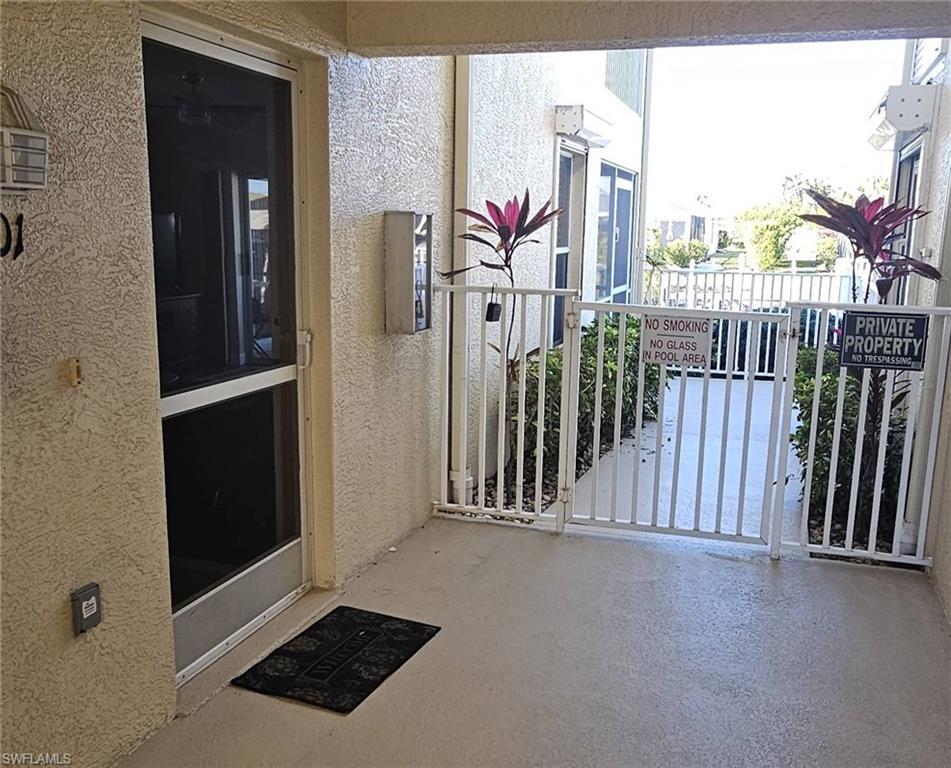 Image 2: View of exterior entry with stucco siding