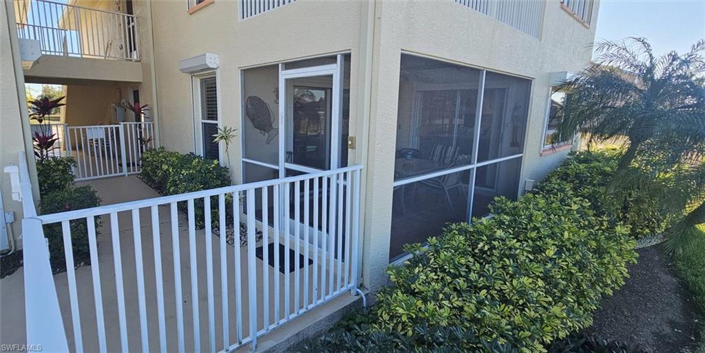 Image 3: View of side of property with stucco siding and a sunroom