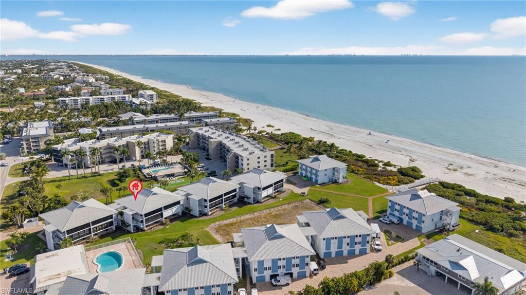 Image 2: Bird's eye view of unending shoreline and apartment complex / building