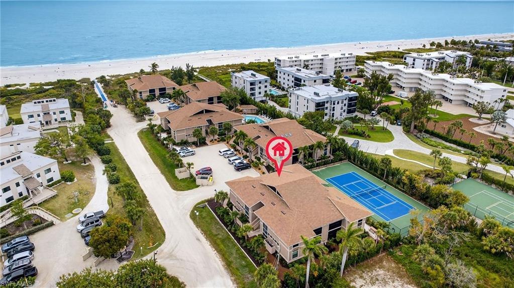 Image 3: Bird's eye view of expansive beach and apartment complex / building