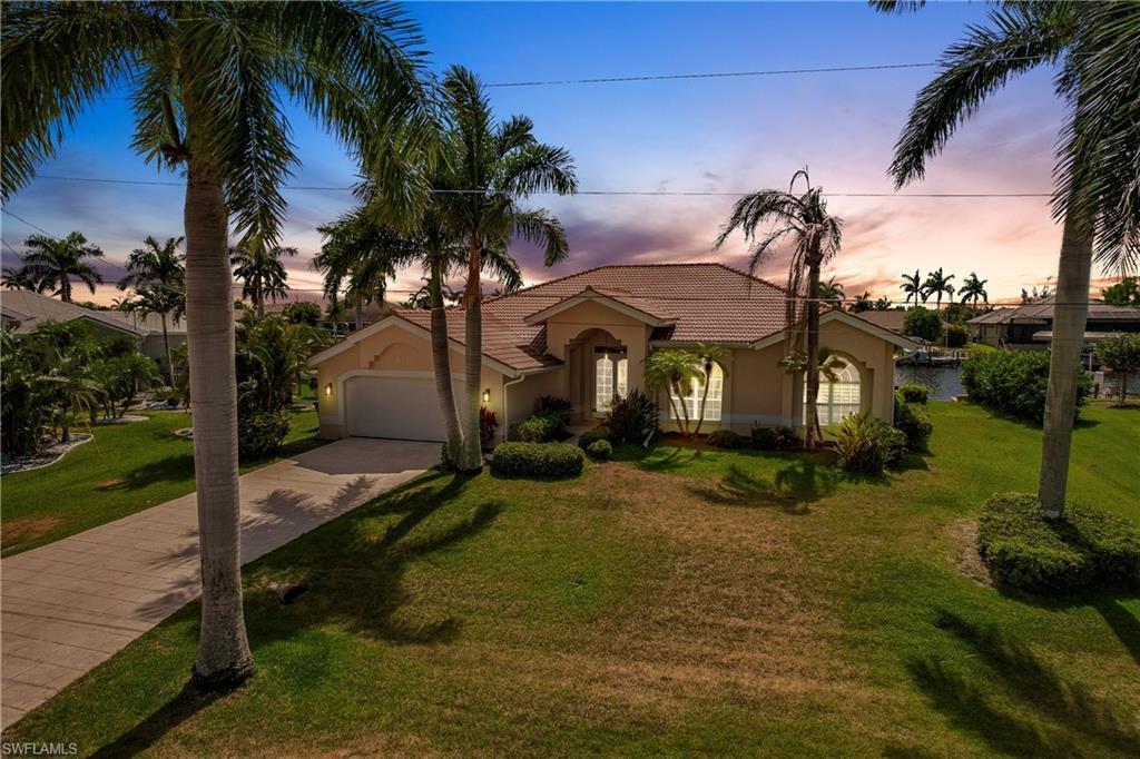 Image 1: Mediterranean / spanish-style home with a garage and a yard