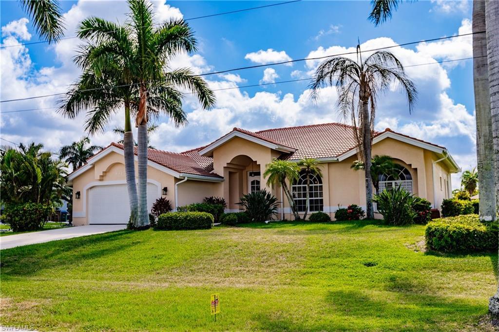 Image 2: Mediterranean / spanish-style home with a front yard and a garage