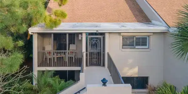 Image 3: View of front of unit featuring catwalk and screened balcony