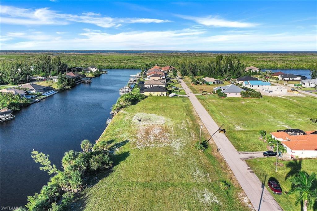 Image 2: Aerial perspective of suburban area featuring a large body of water