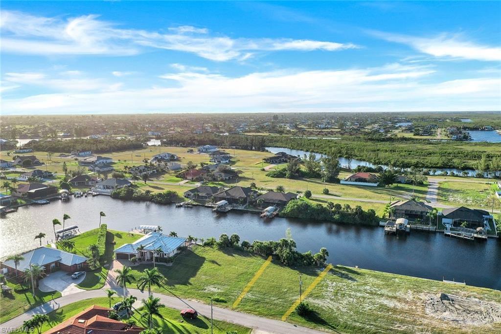 Image 3: Aerial perspective of suburban area featuring a large body of water