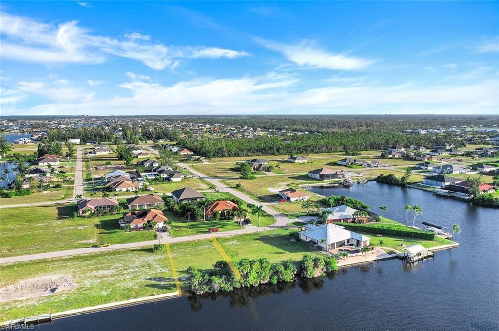 Image 4: Aerial perspective of suburban area featuring a large body of water