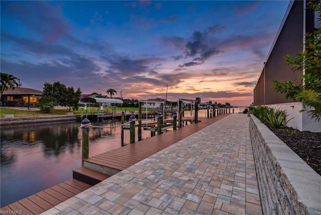 Image 1: Dock area featuring boat lift and a water view