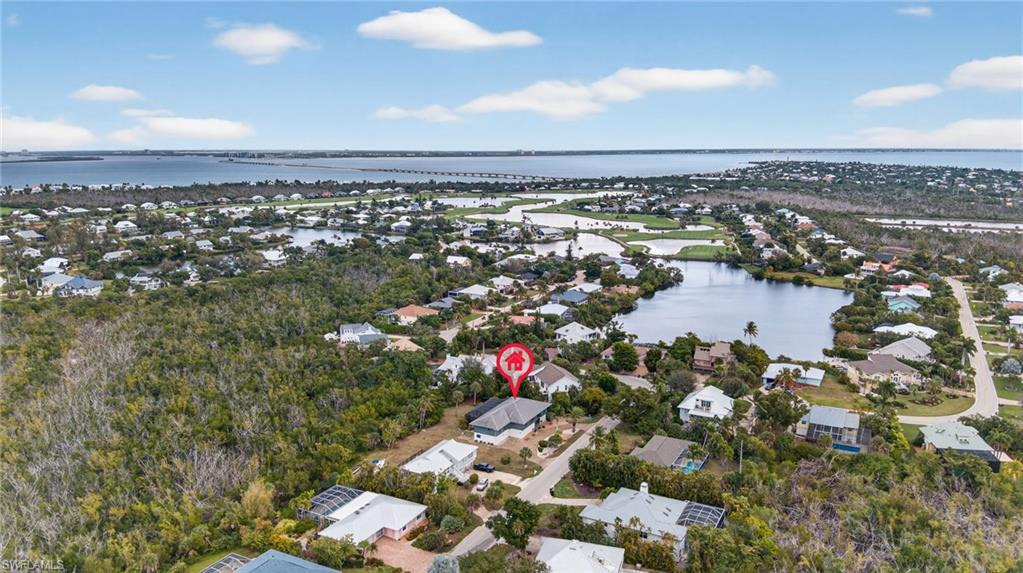 Image 2: Aerial perspective of suburban area with a nearby body of water