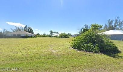 Image 1: View of grassy yard featuring a view of countryside