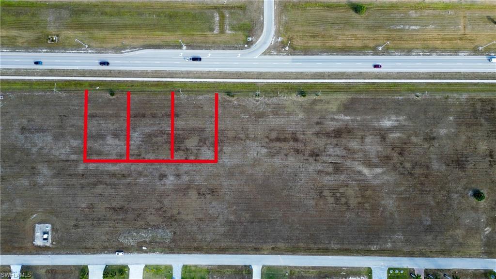 Image 2: Aerial view of property's location featuring property parcel outlined