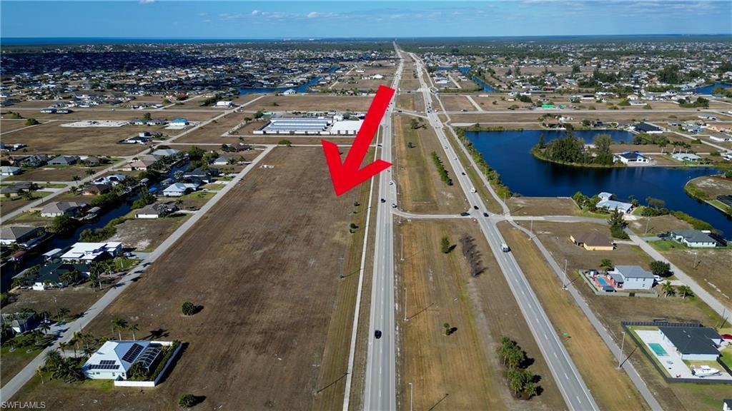 Image 3: View of property location with nearby suburban area and a large body of water