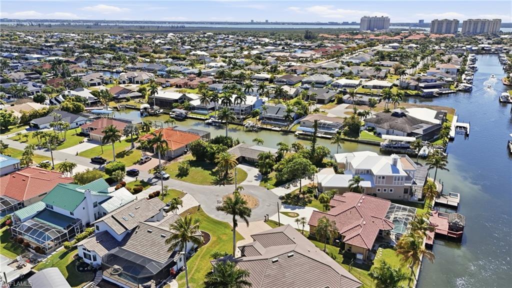 Image 4: Aerial view of property's location featuring a large body of water and nearby suburban area