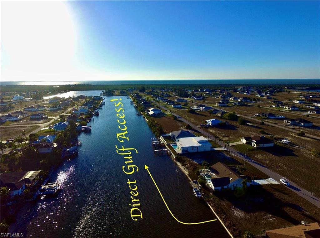Image 3: Aerial perspective of suburban area with a large body of water
