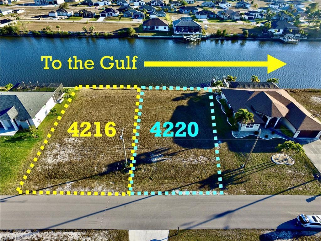 Image 2: Aerial view of residential area featuring a large body of water