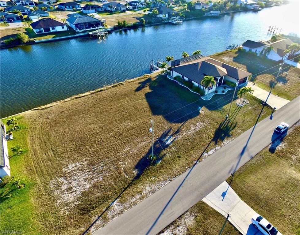 Image 4: Aerial perspective of suburban area with a nearby body of water