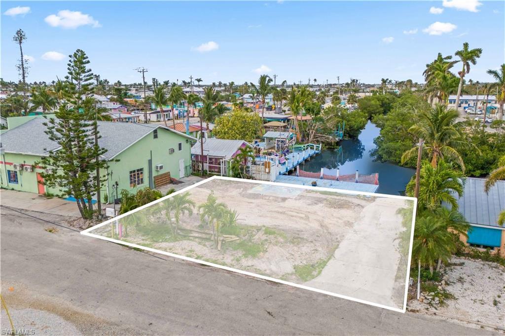 Image 1: Direct sailboat access, stunning water views, abundant wildlife, and easy access to local amenities, making it the perfect location for your custom home in a vibrant, reemerging island community.