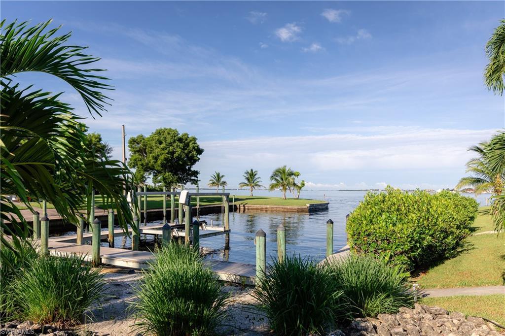 Image 3: Dock featuring boat lift and a water view