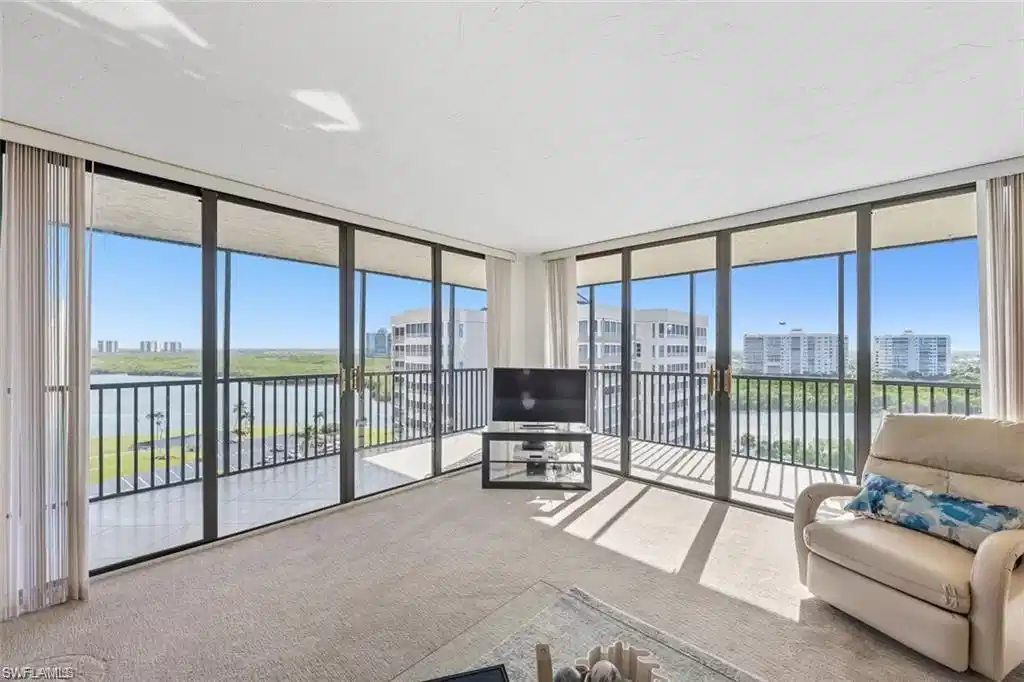Image 1: Carpeted living area featuring a wall of windows