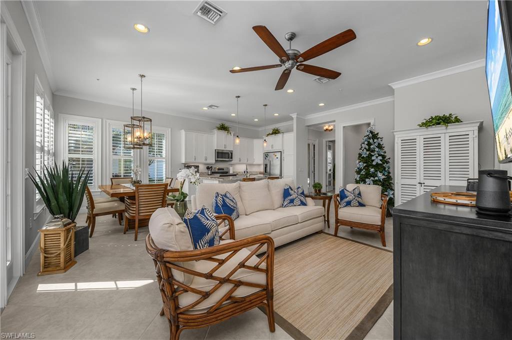 Image 4: Living room featuring ornamental molding, a ceiling fan, recessed lighting, and a chandelier