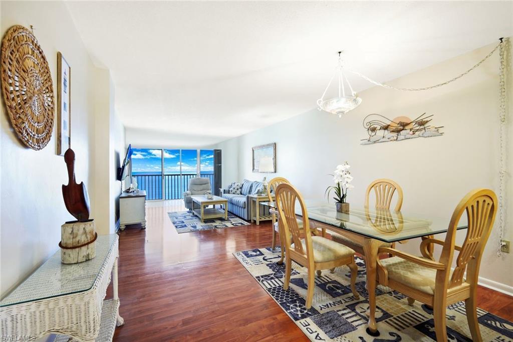 Image 4: Dining room with dark wood finished floors