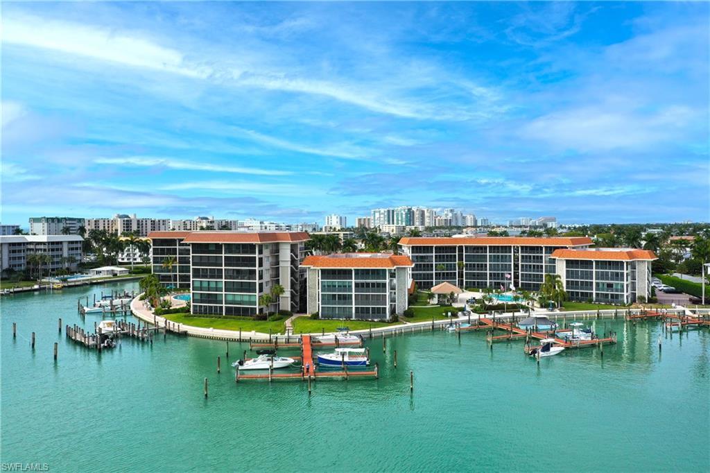 Image 2: Water view with a boat dock and nearby urban area