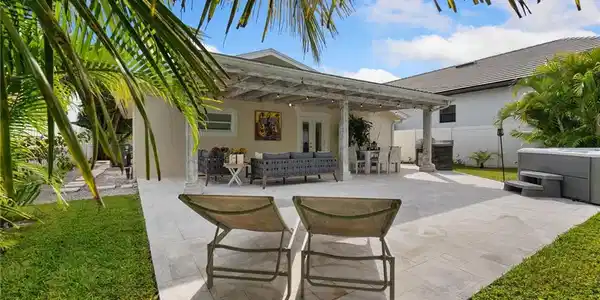 Image 2: View of patio featuring an outdoor hangout area, a hot tub, french doors, and outdoor dining space