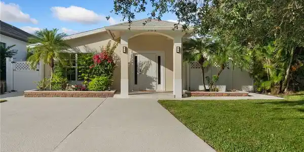 Image 4: View of front facade featuring stucco siding