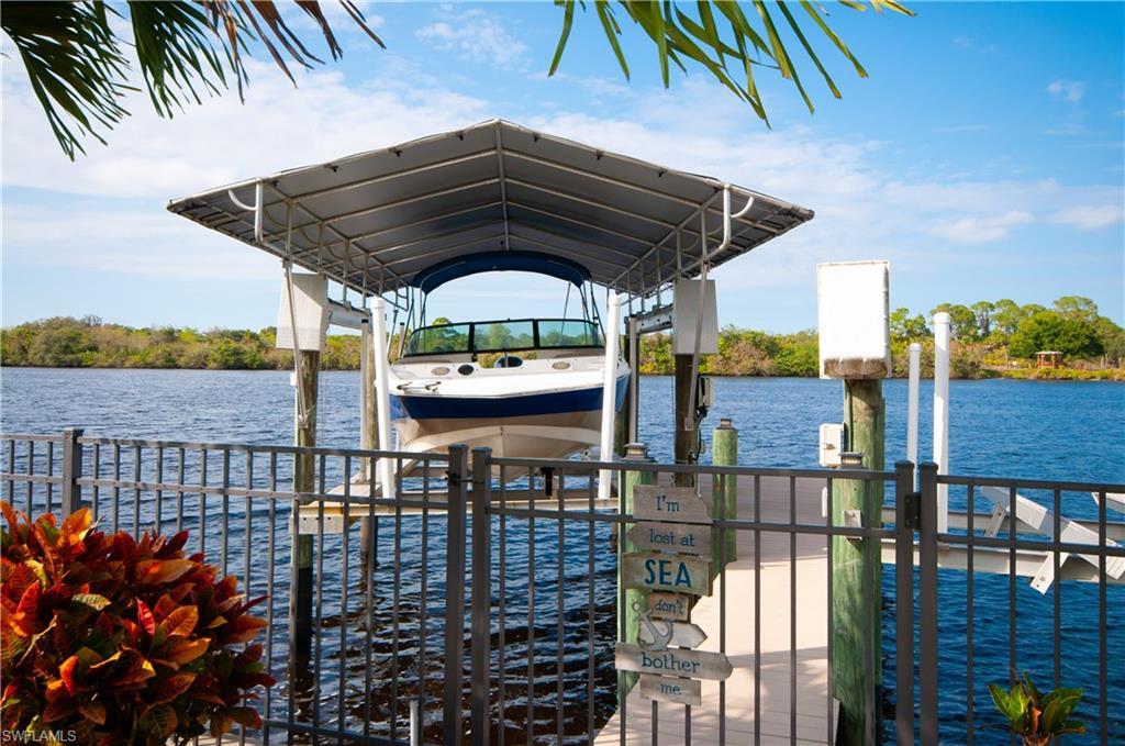 Image 4: Dock area with boat lift and a water view
