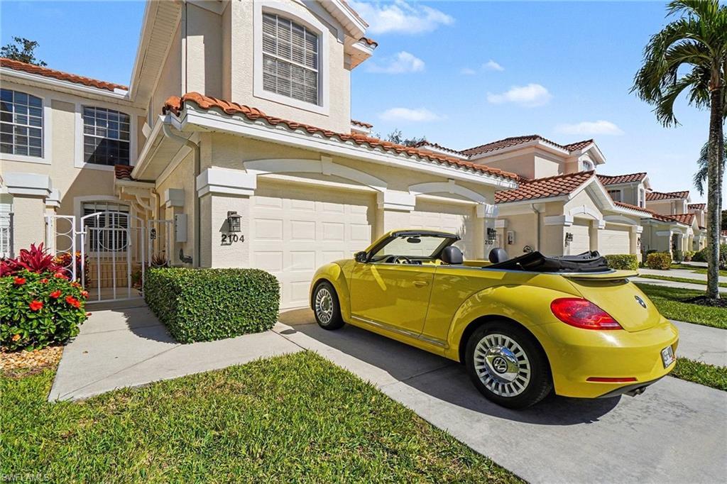Image 2: Mediterranean / spanish home with stucco siding, driveway, a tile roof, and an attached garage