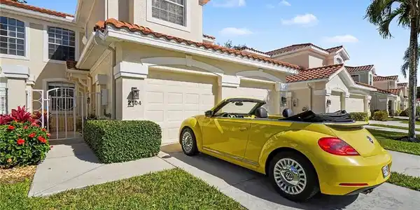 Image 2: Mediterranean / spanish home with stucco siding, driveway, a tile roof, and an attached garage