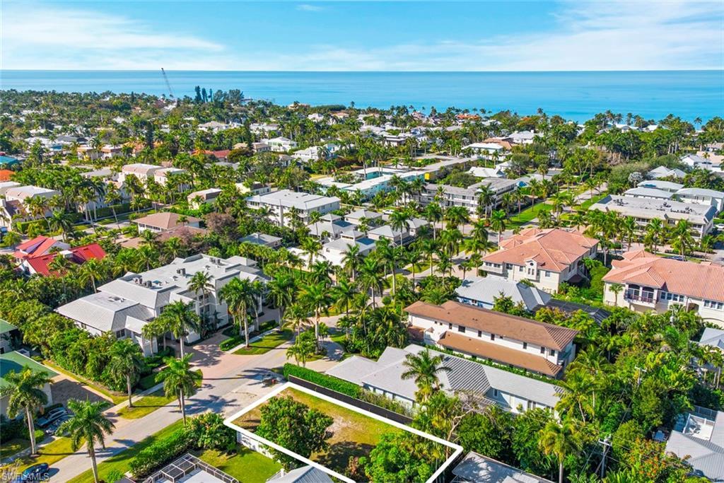 Image 4: Aerial perspective of suburban area featuring a nearby body of water