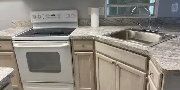 Image 3: Kitchen featuring white appliances, light brown cabinets, and light countertops