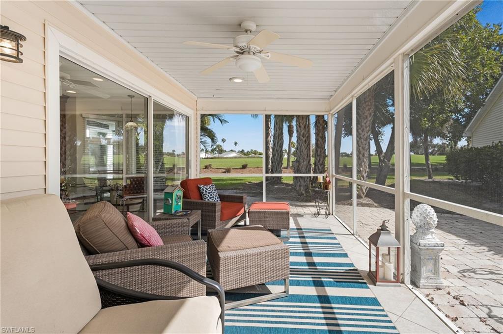 Image 1: A sun-soaked screened lanai and expansive pavered patio provide the perfect setting for entertaining or enjoying the action on the golf course.